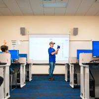 Teacher in a classroom full of students.